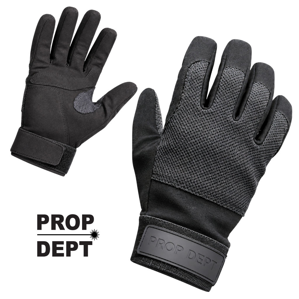 A pair of black work gloves shown on a white background, one glove oriented to show the back of the hand and the other to show the palm side. The gloves feature textured mesh panels on the palms and backs, solid fabric sections, and a visible 'PROP DEPT' logo patch on the cuff.
