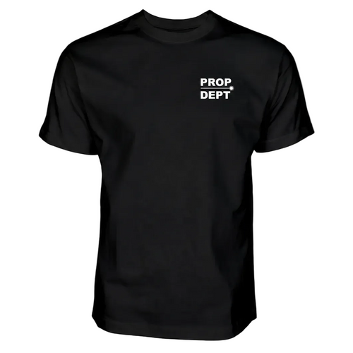A black short-sleeve crewneck t-shirt with 'PROP DEPT' printed in white block letters and a white arrow on the left chest, displayed on a solid white background.