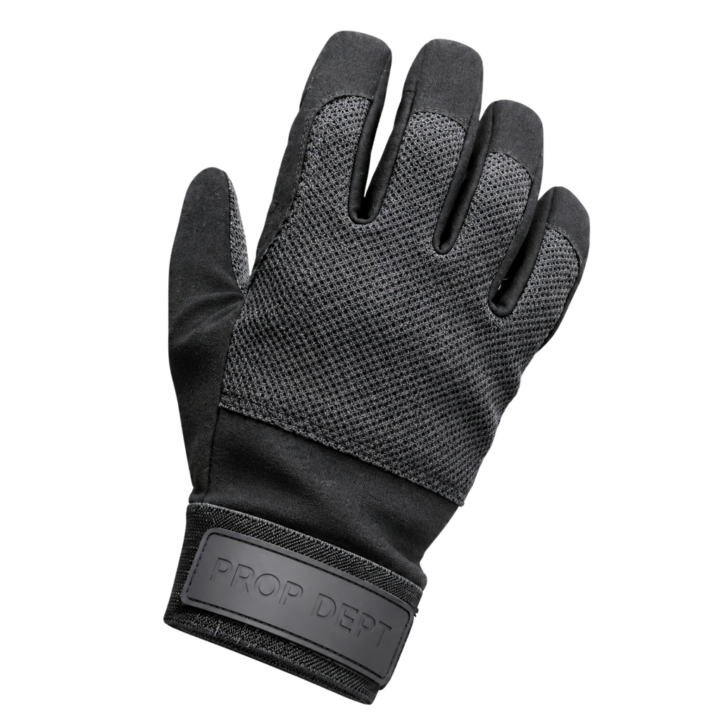 A single black Prop Dept. work glove with textured mesh backhand panels and a solid black wrist strap featuring the embossed brand name.